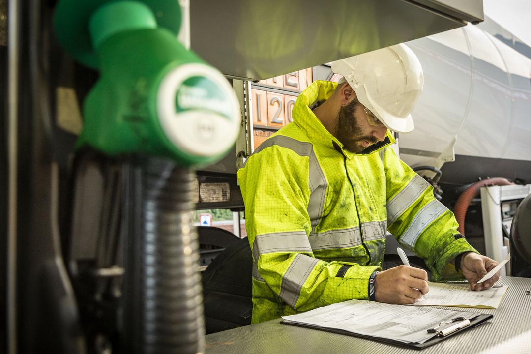 RAF Logistics Driver fills out paper work at petrol pump.